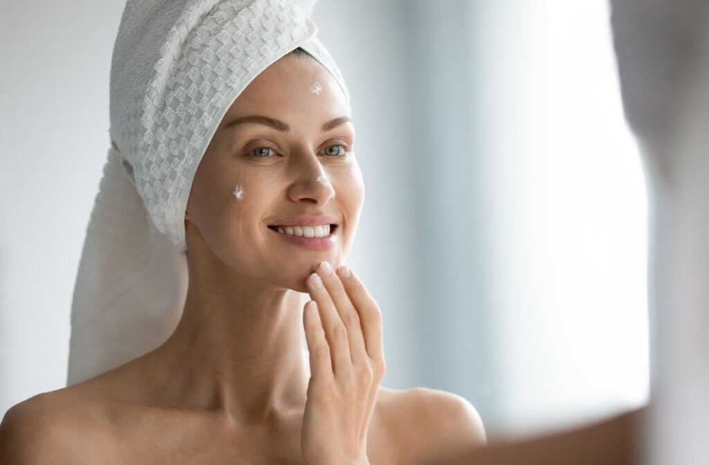 Woman applying moisturiser as part of a simple morning skincare routine