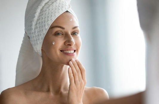 Woman applying moisturiser as part of a simple morning skincare routine