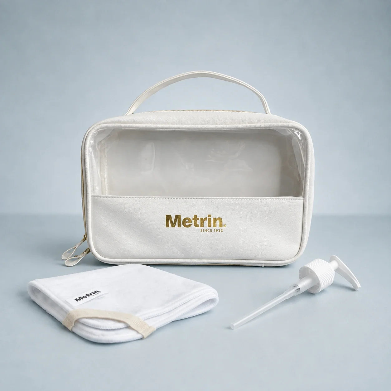 Metrin skincare accessories including cosmetic bag, cleansing cloth and pump dispenser.